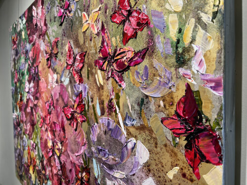 Close-up detail showing the raised palette-knife impasto texture and vibrant colors in Maya Eventov's Butterflies in Vivid Flight.