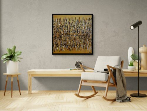 Aro Démarque-toi gold abstract painting displayed on a textured grey plaster wall with blond wood furniture