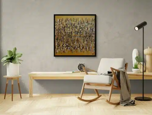 Aro Démarque-toi gold abstract painting displayed on a textured grey plaster wall with blond wood furniture