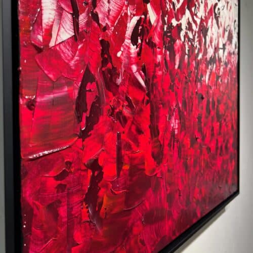 Close-up detail of Élan vital by Aro showing scarlet and rose impasto strokes with glossy wet ridges