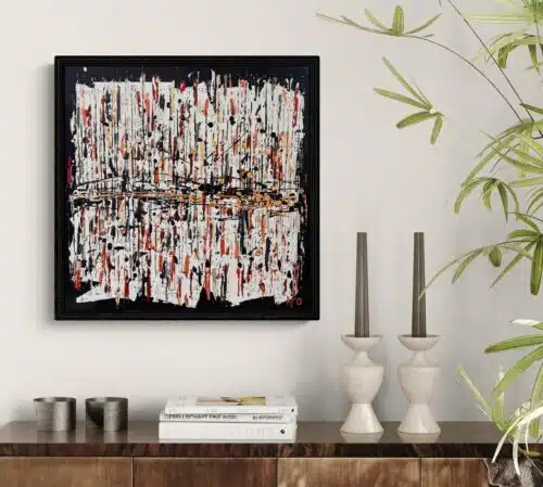 Aro Enjoy the ride painting displayed on a cream wall above a walnut sideboard