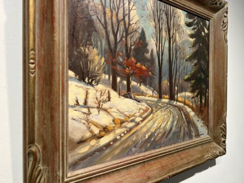 Side angle view of the carved wood frame on Early Evening Winter Road Scene by Frank Panabaker