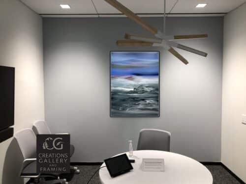 Phantom Realm by Patricia Gagic displayed on the wall of a modern office meeting room